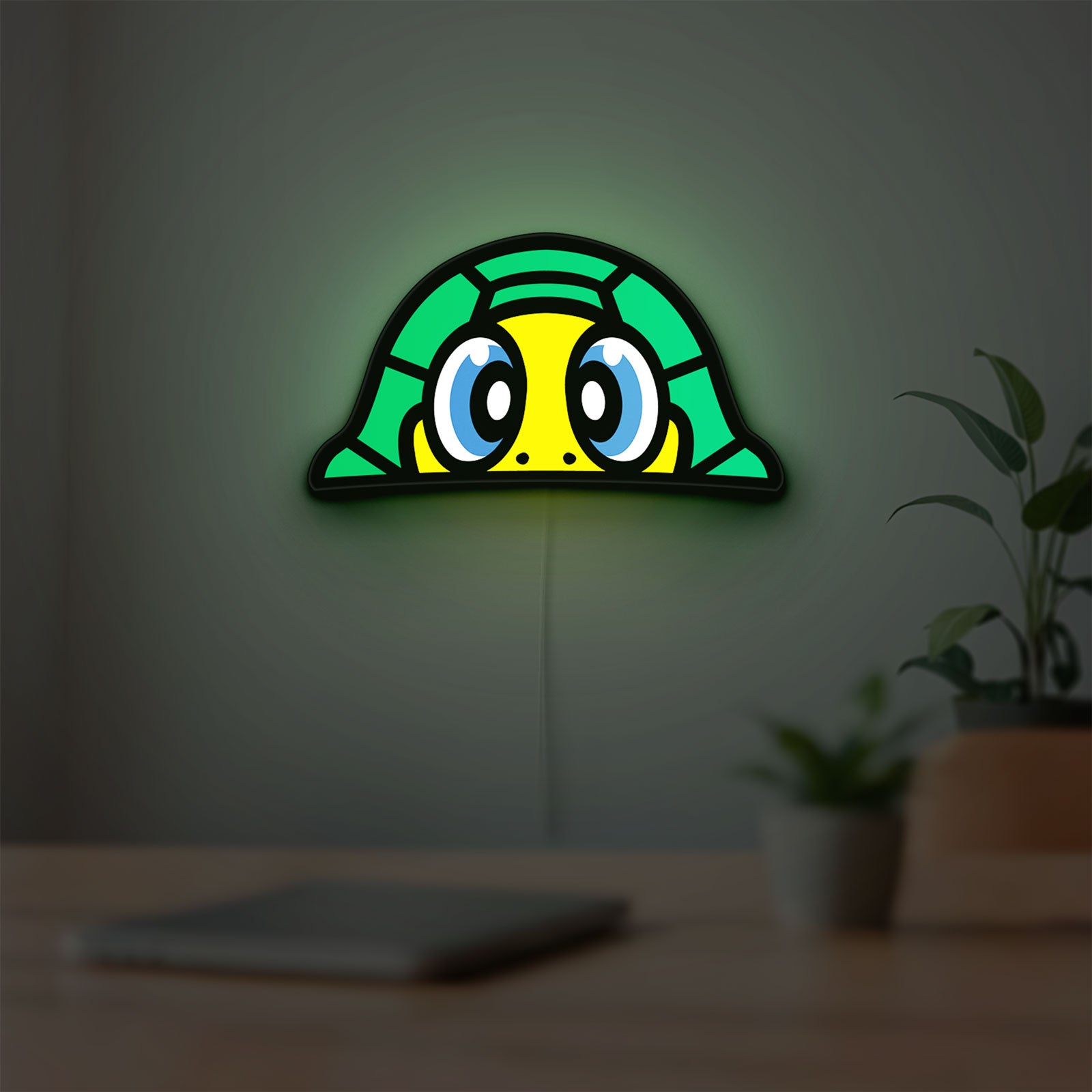 TURTLE ROSSI LED lightbox hanging on a room wall with soft green light