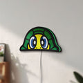 Unlit TURTLE ROSSI LED lightbox mounted on a wall in daylight