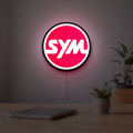 SYM Sanyang Scooters Motorcycle LED lightbox hanging on a room wall with soft red light