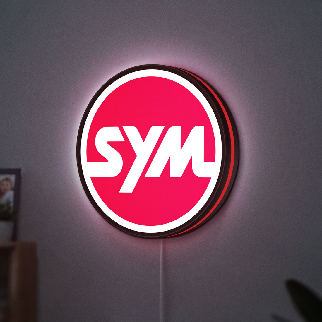 SYM Sanyang Scooters Motorcycle LED lightbox hanging on a wall with red glow