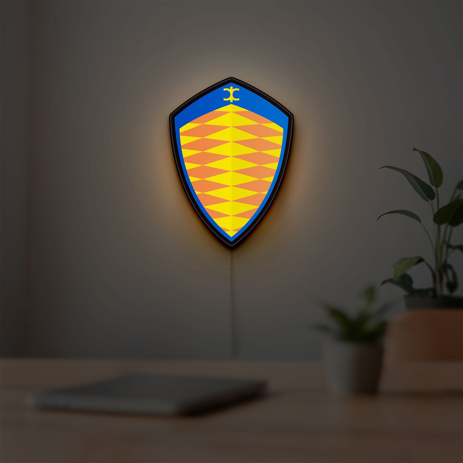 Koenigsegg LED lightbox hanging on a room wall with soft yellow light