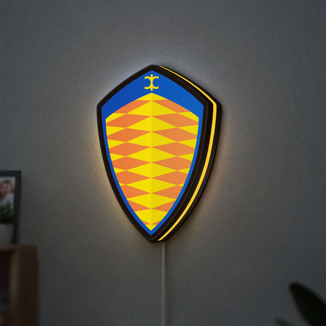 Koenigsegg LED lightbox hanging on a wall with yellow glow