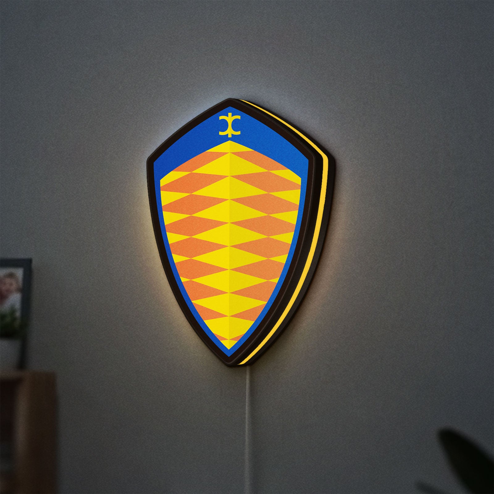 Koenigsegg LED lightbox hanging on a wall with yellow glow
