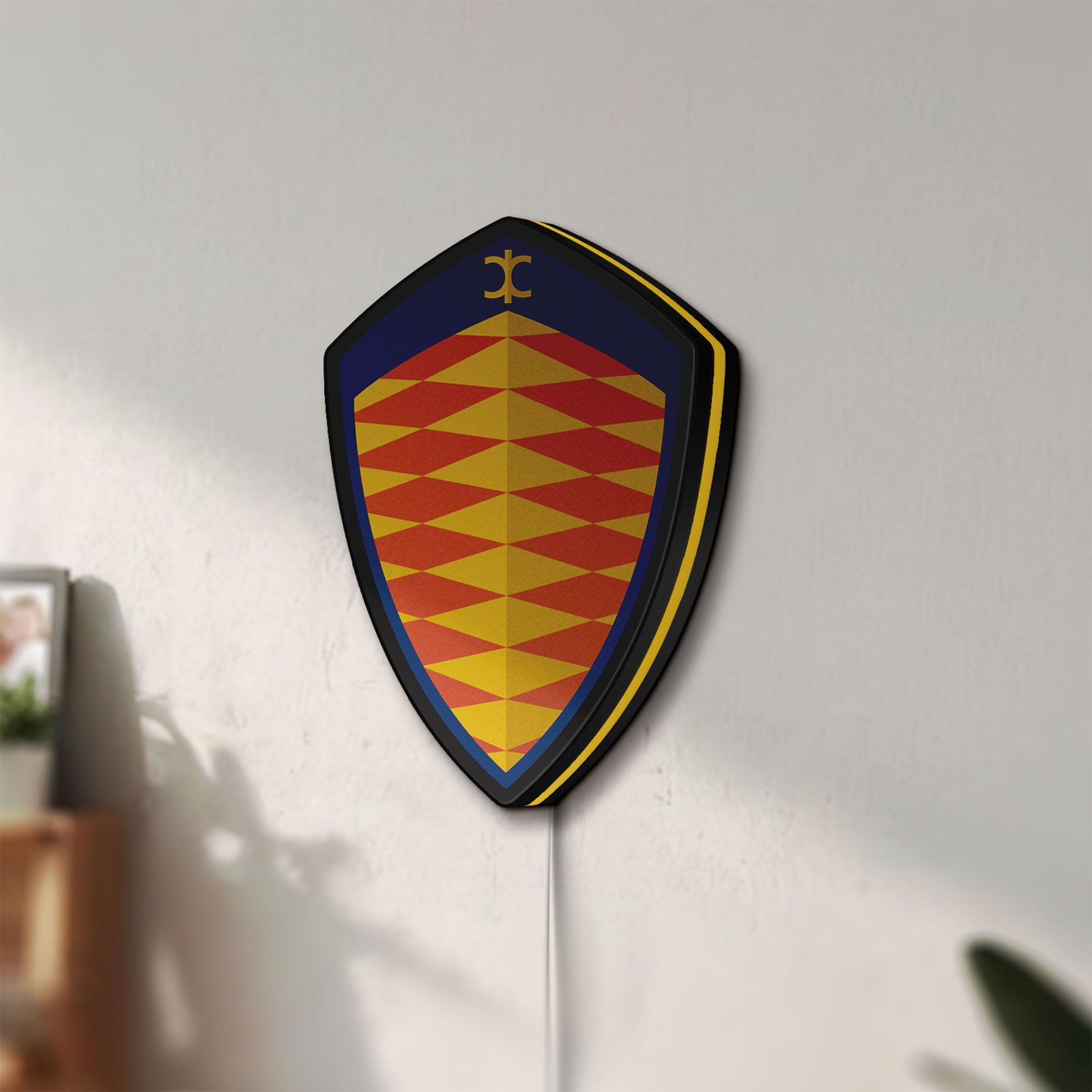 Unlit Koenigsegg LED lightbox mounted on a wall in daylight