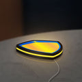 Koenigsegg LED lightbox lying flat on a desk with yellow glow