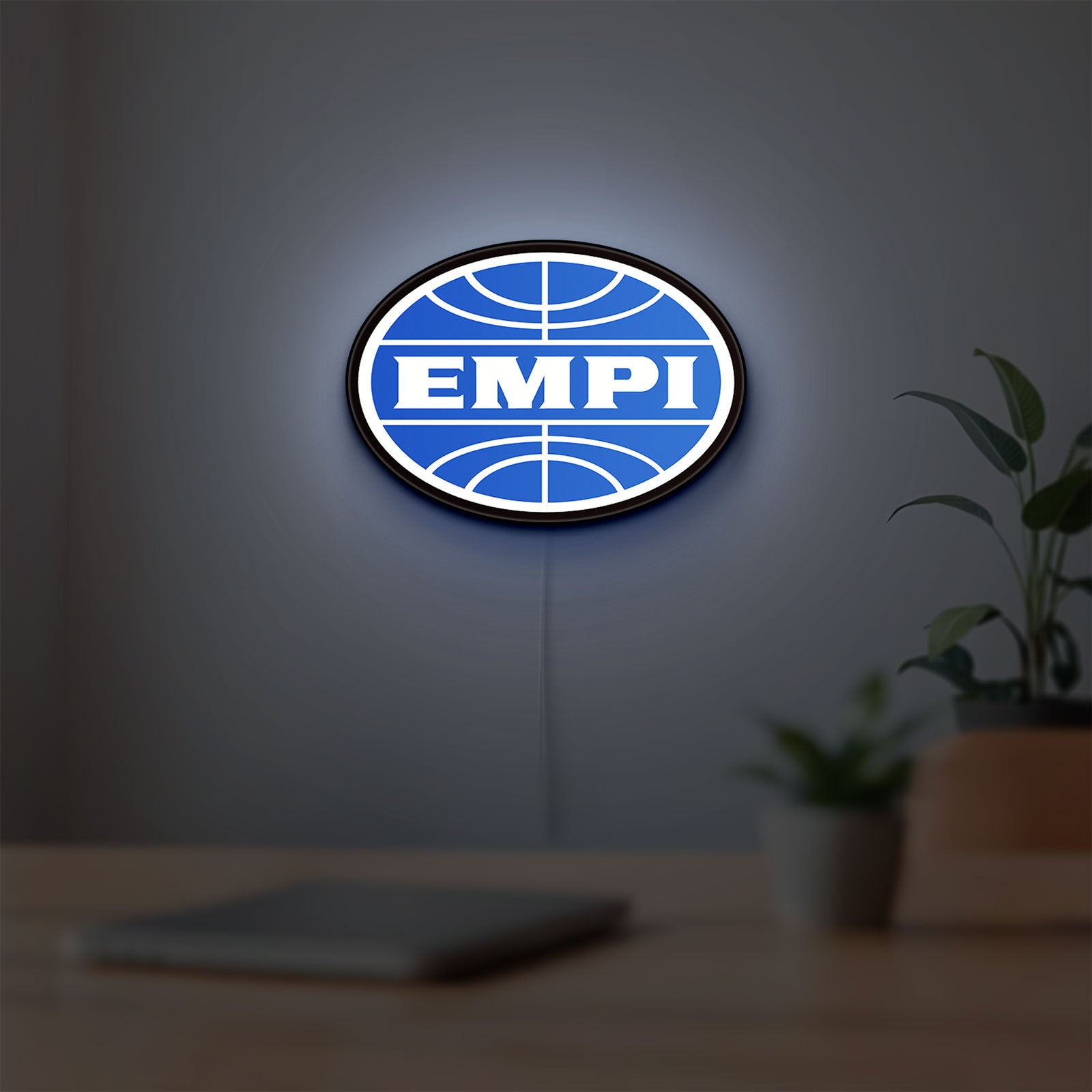 EMPI Volkswagen LED lightbox hanging on a room wall with soft blue light