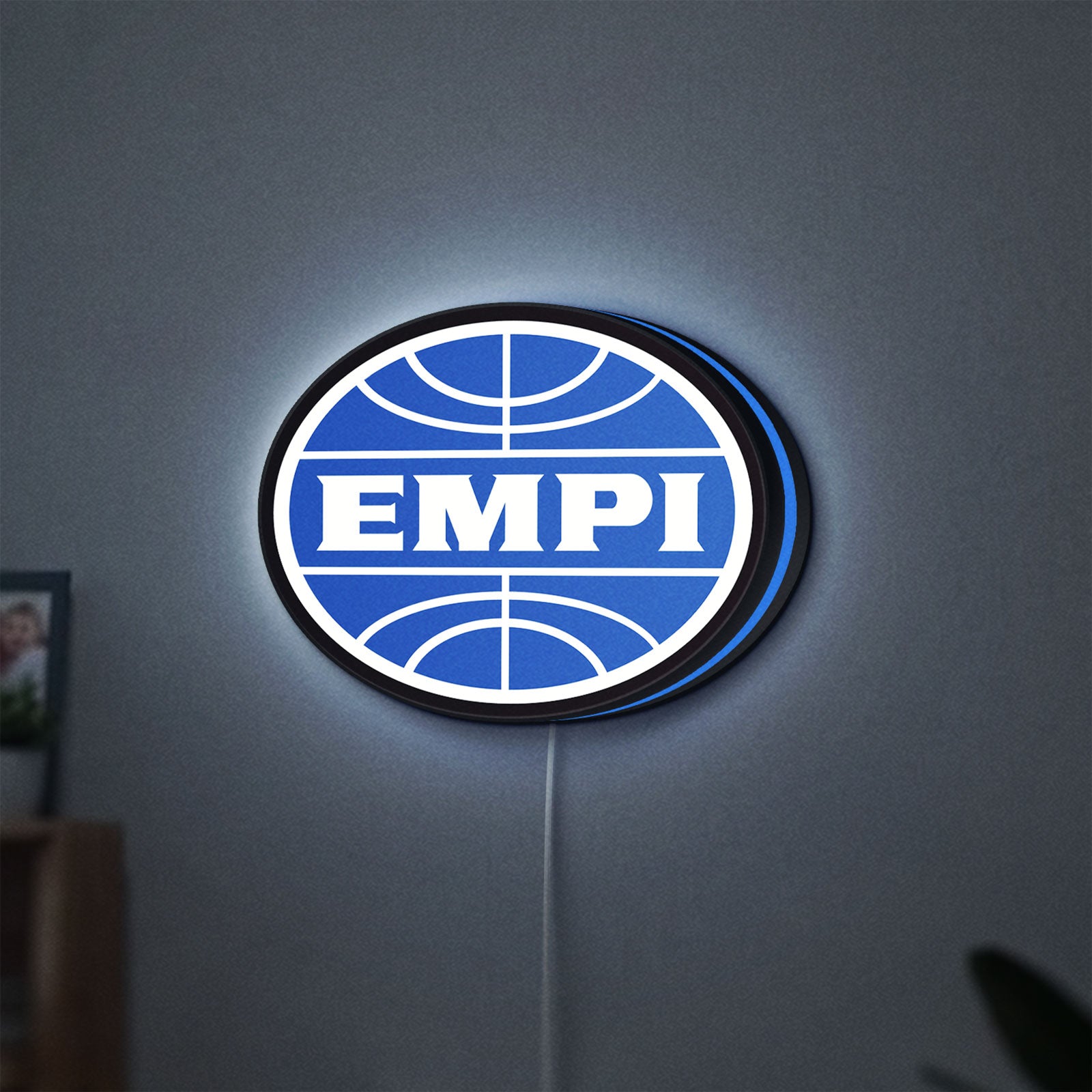 EMPI Volkswagen LED lightbox hanging on a wall with blue glow
