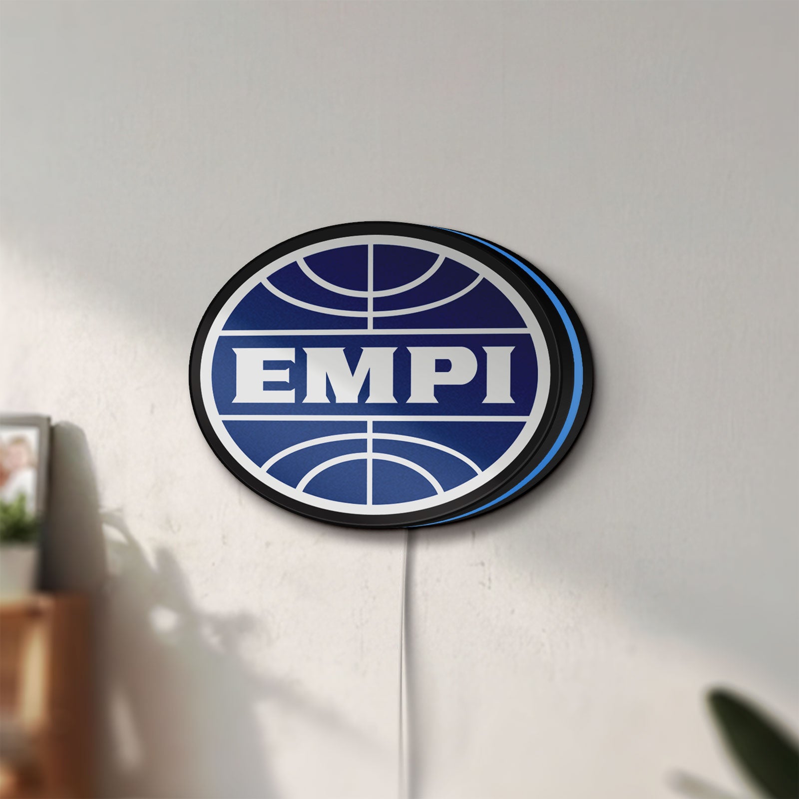 Unlit EMPI Volkswagen LED lightbox mounted on a wall in daylight