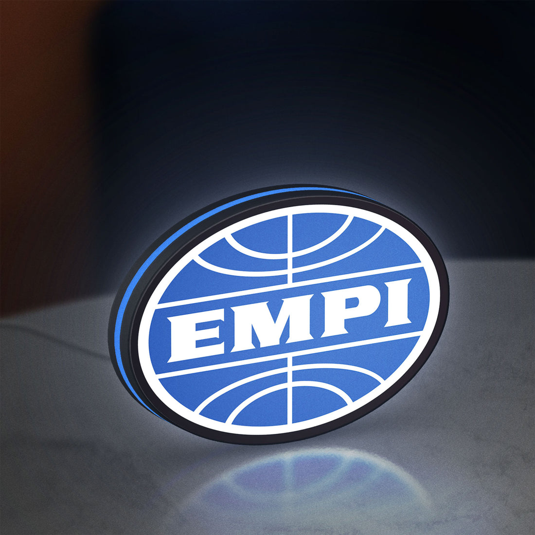 EMPI Volkswagen LED lightbox hanging on a wall with blue glow