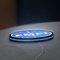 EMPI Volkswagen LED lightbox lying flat on a desk with blue glow