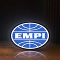 Front view of EMPI Volkswagen LED lightbox sign glowing on a wooden desk