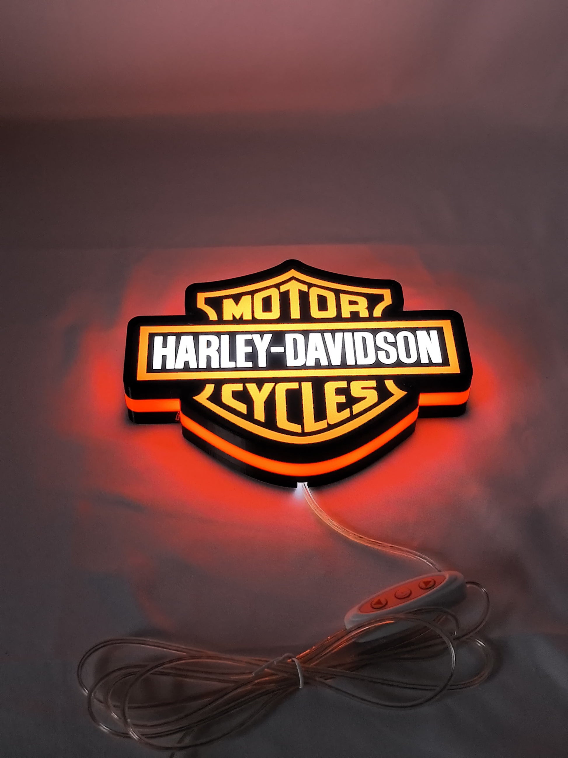 Illuminated flat lay angled view of Harley Davidson 3D LED Sign in 20cm, unique wall art for desk and room decor