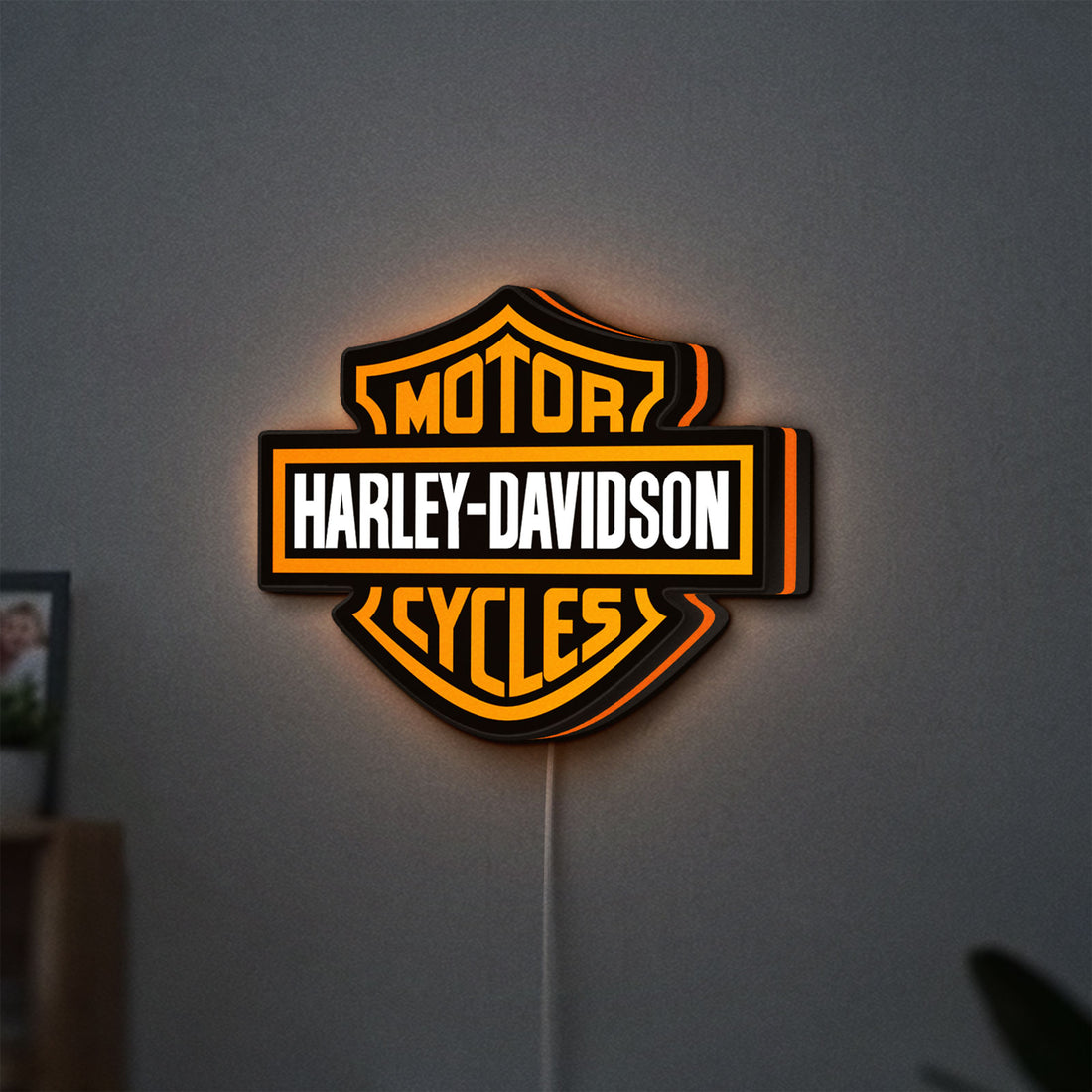 Harley Davidson LED lightbox hanging on a wall with orange glow