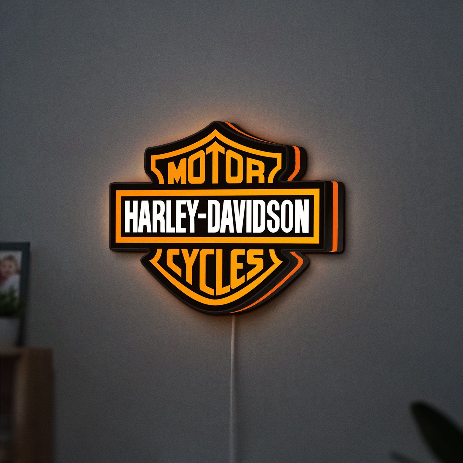 Harley Davidson LED lightbox hanging on a wall with orange glow