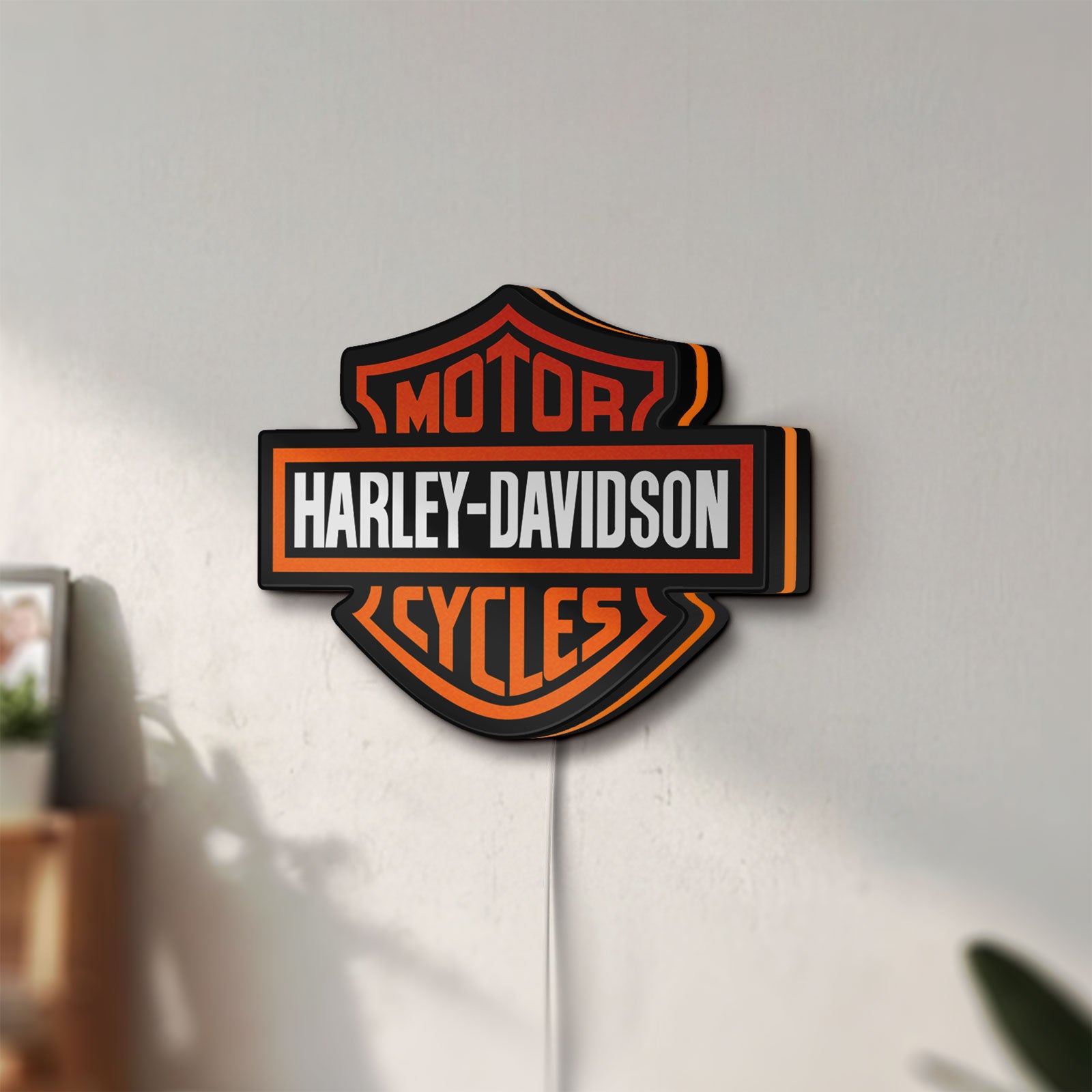 Unlit Harley Davidson LED lightbox mounted on a wall in daylight