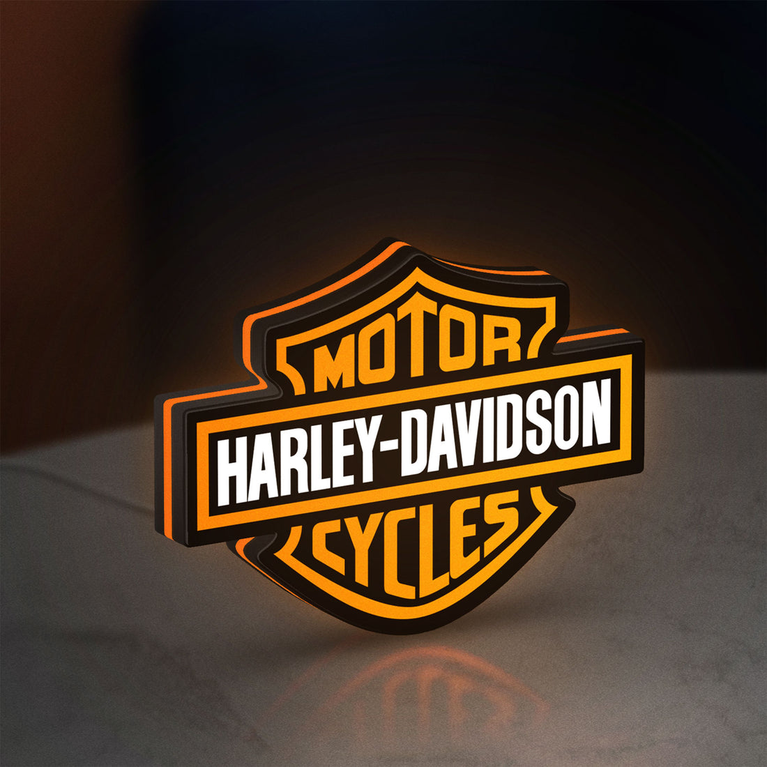 Harley Davidson LED lightbox hanging on a wall with orange glow