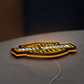 Harley Davidson LED lightbox lying flat on a desk with orange glow