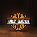 Front view of Harley Davidson LED lightbox sign glowing on a wooden desk