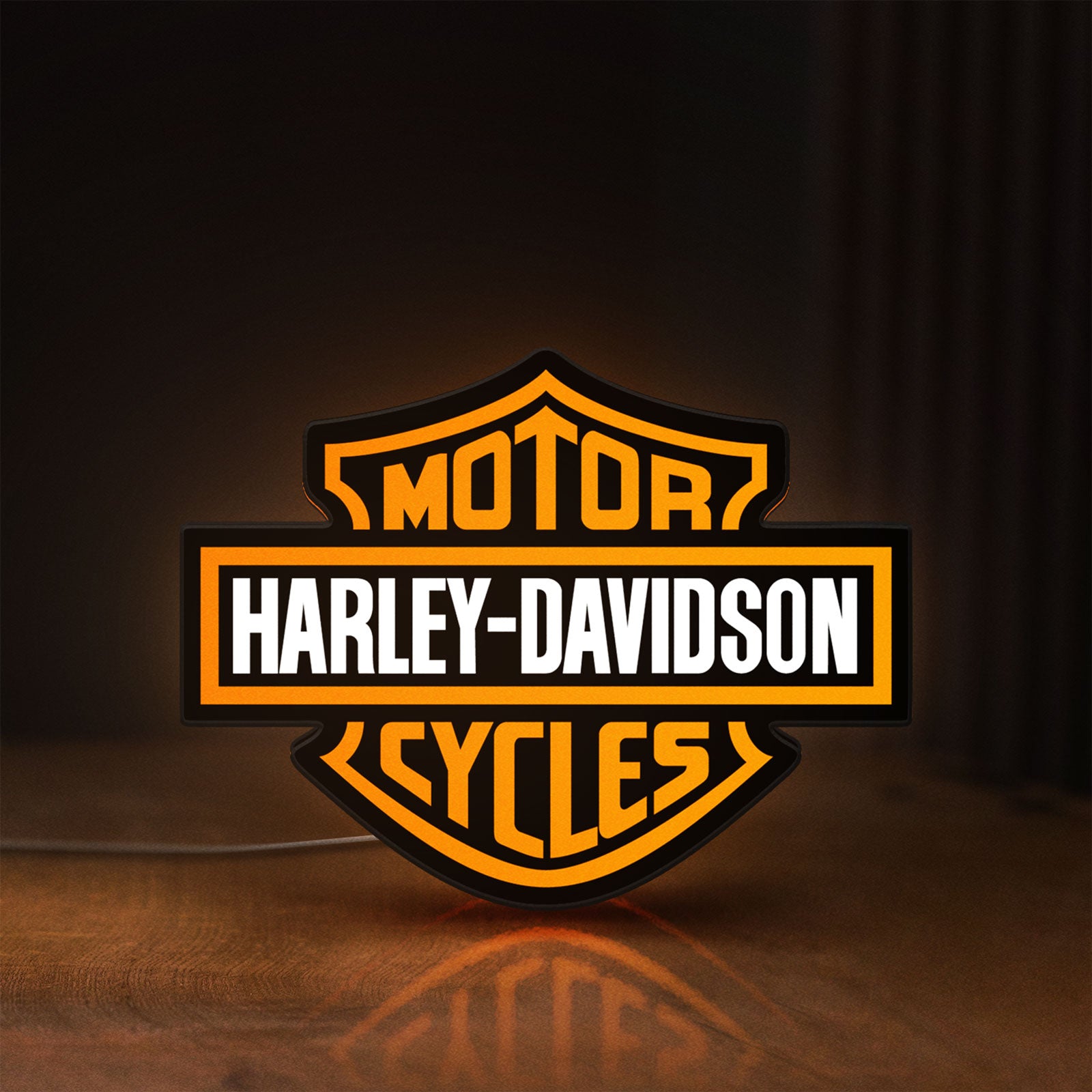 Front view of Harley Davidson LED lightbox sign glowing on a wooden desk