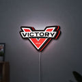 Victory Motorcycles LED lightbox hanging on a wall with red glow