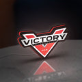 Victory Motorcycles LED lightbox standing on a desk from an angled side view with red glow