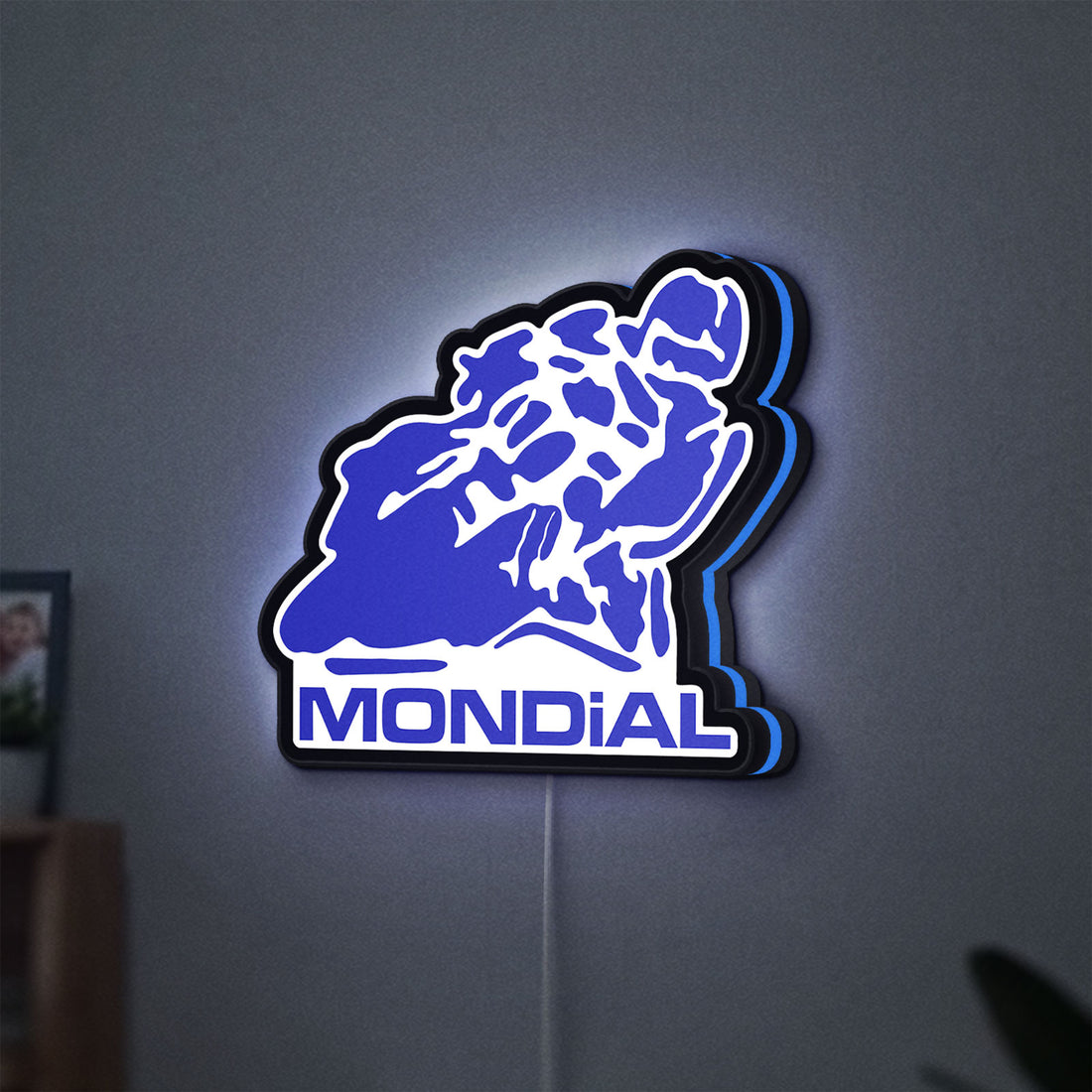Mondial Motorcycle LED lightbox hanging on a wall with blue glow