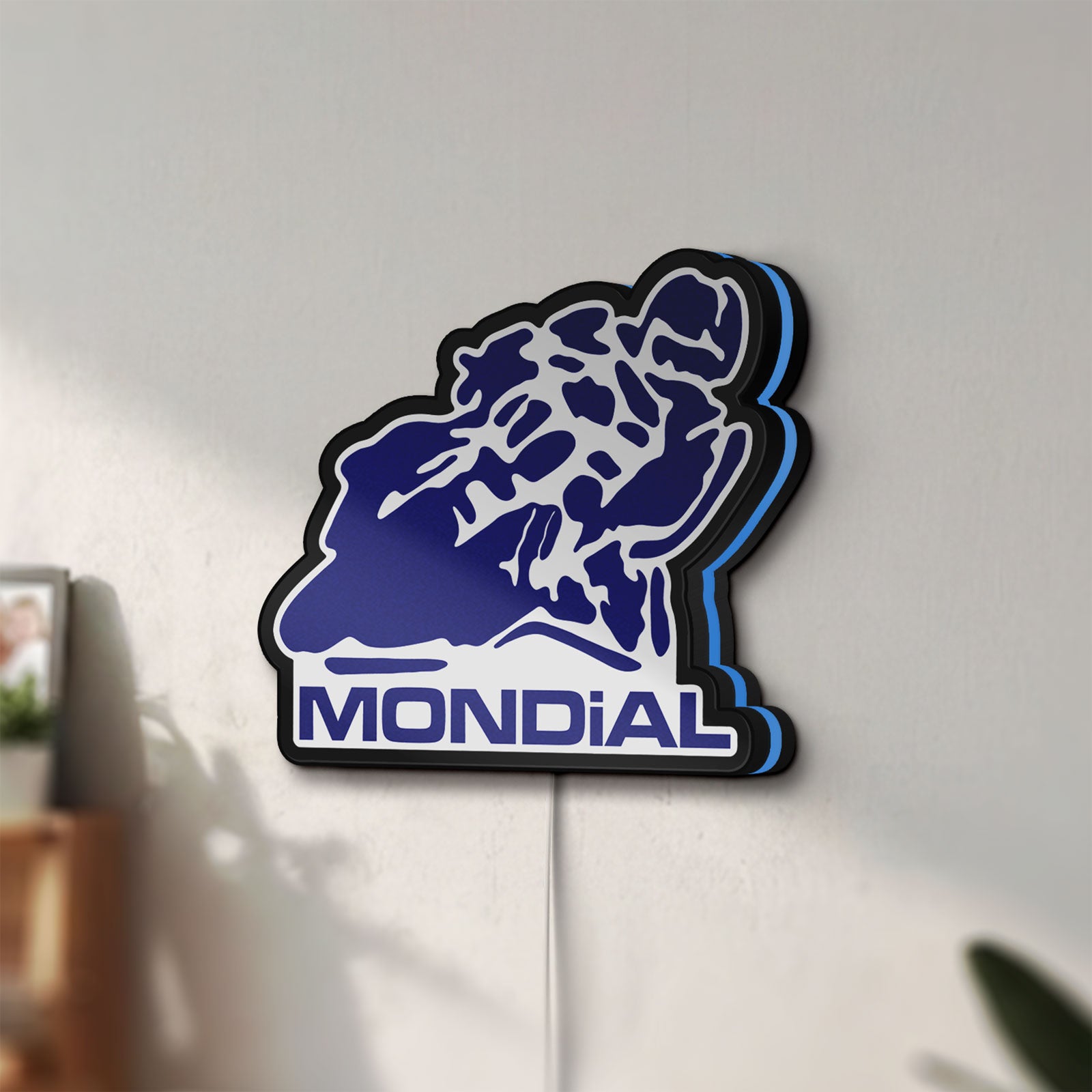 Unlit Mondial Motorcycle LED lightbox mounted on a wall in daylight