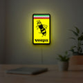 Vespa LED lightbox hanging on a room wall with soft yellow light