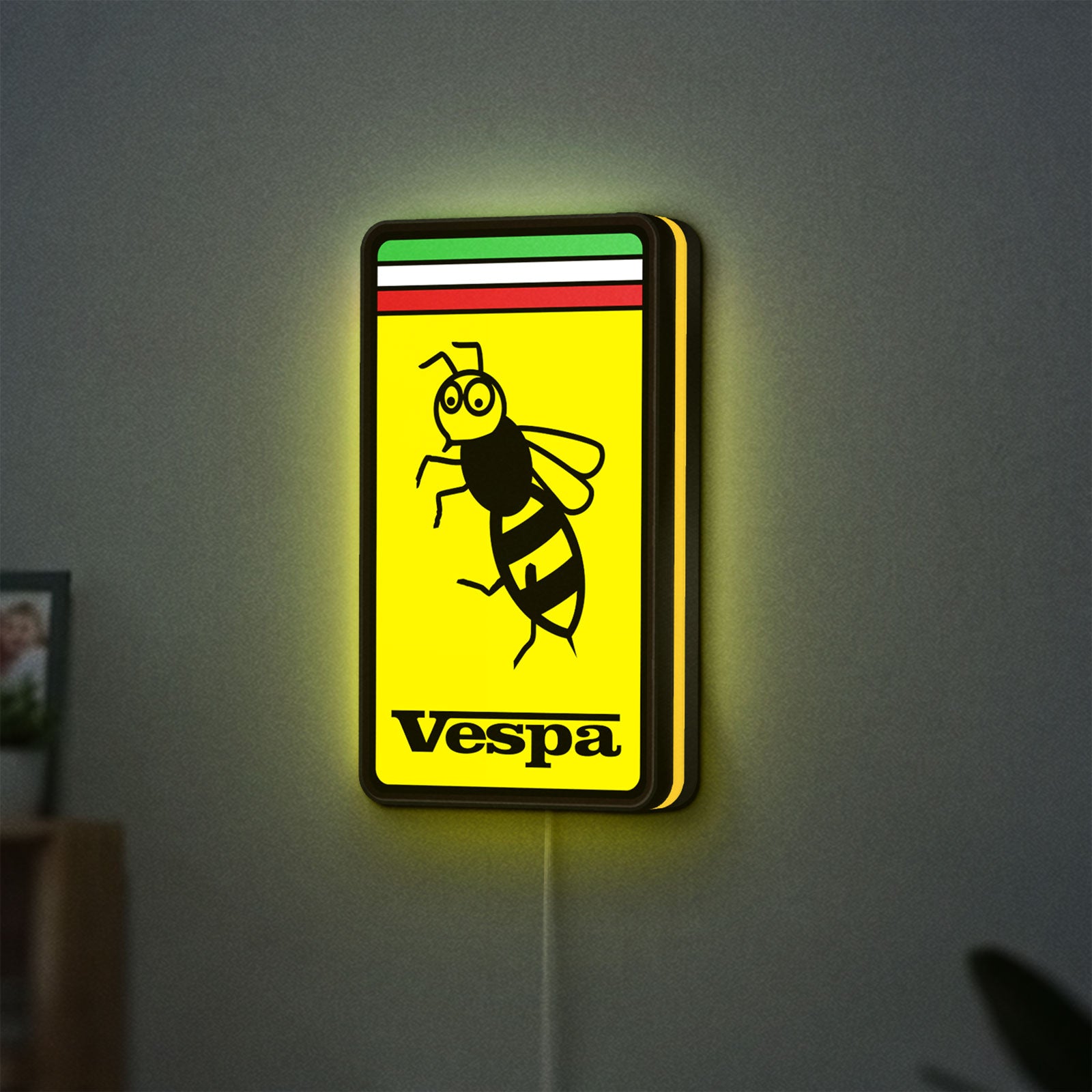 Vespa LED lightbox hanging on a wall with yellow glow