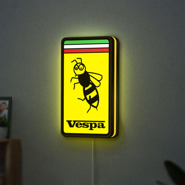 Vespa LED lightbox hanging on a wall with yellow glow