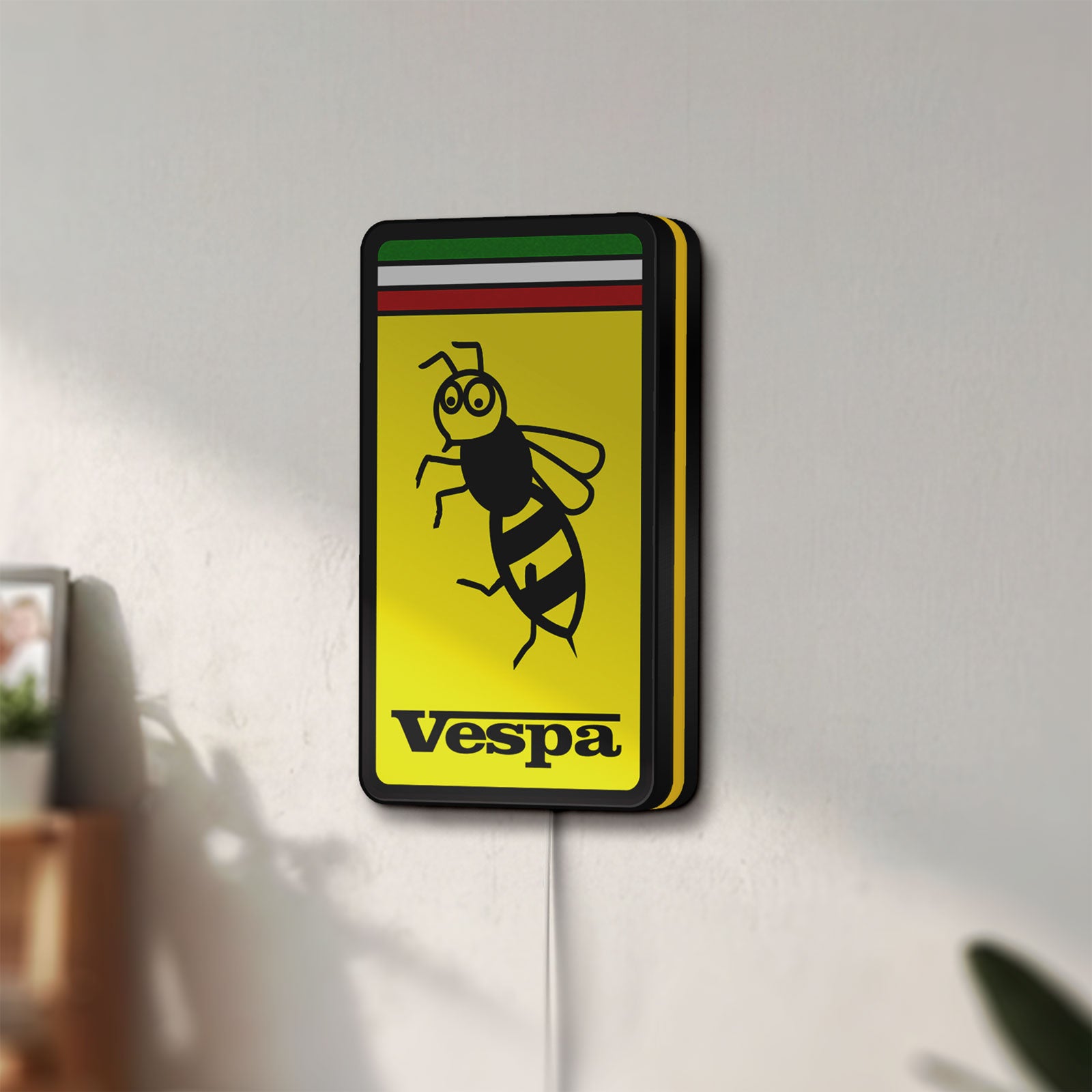 Unlit Vespa LED lightbox mounted on a wall in daylight
