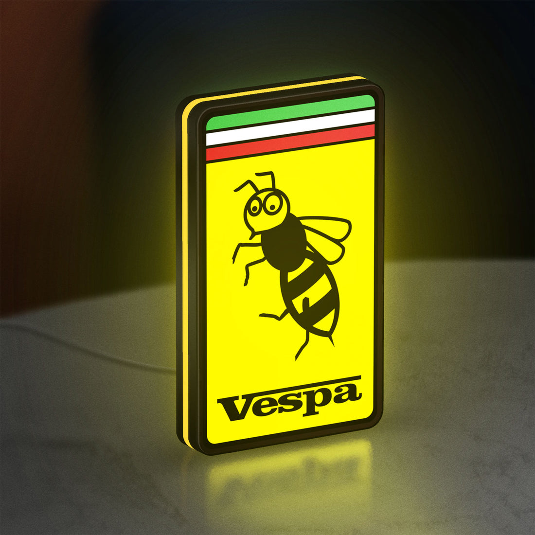 Vespa LED lightbox hanging on a wall with yellow glow