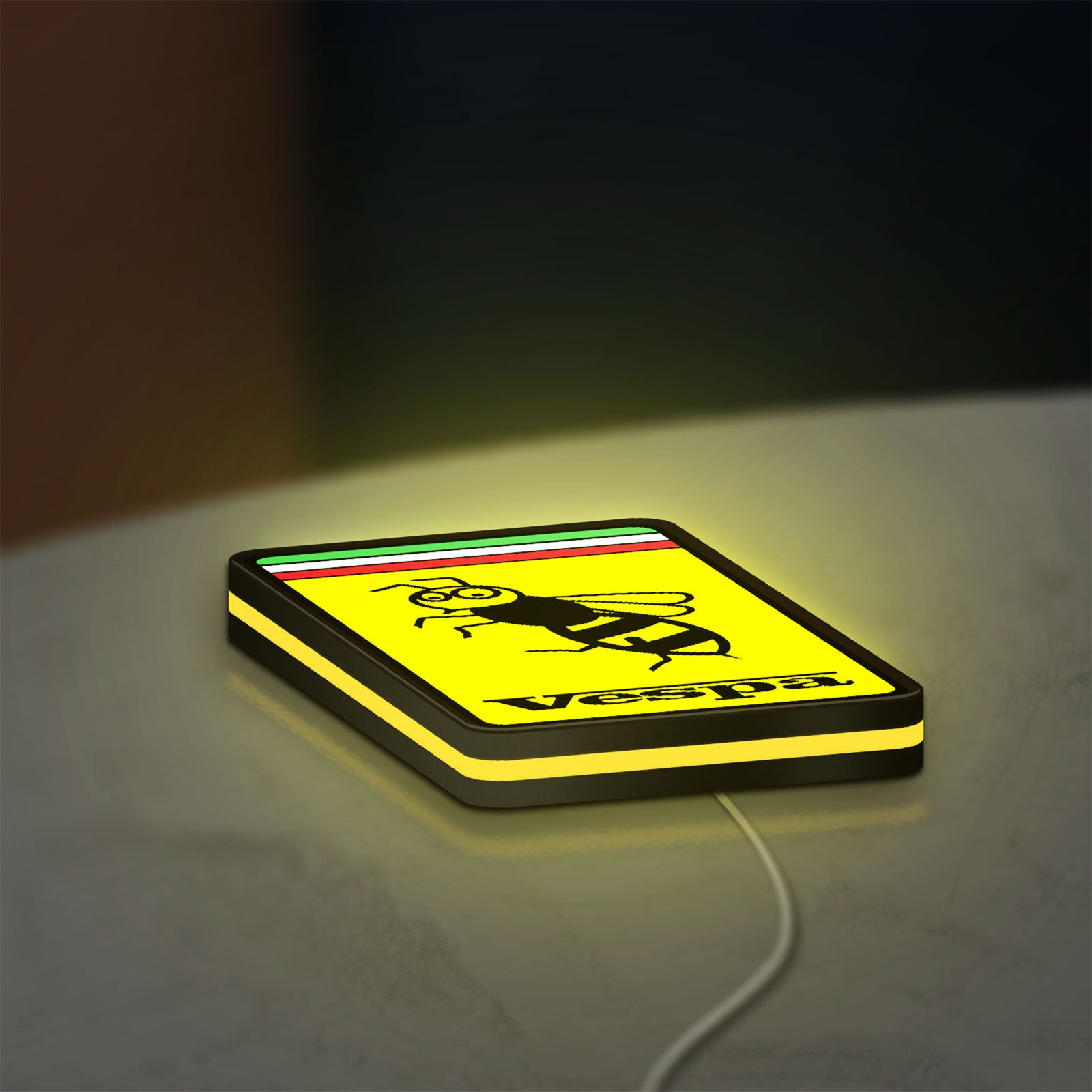Vespa LED lightbox lying flat on a desk with yellow glow