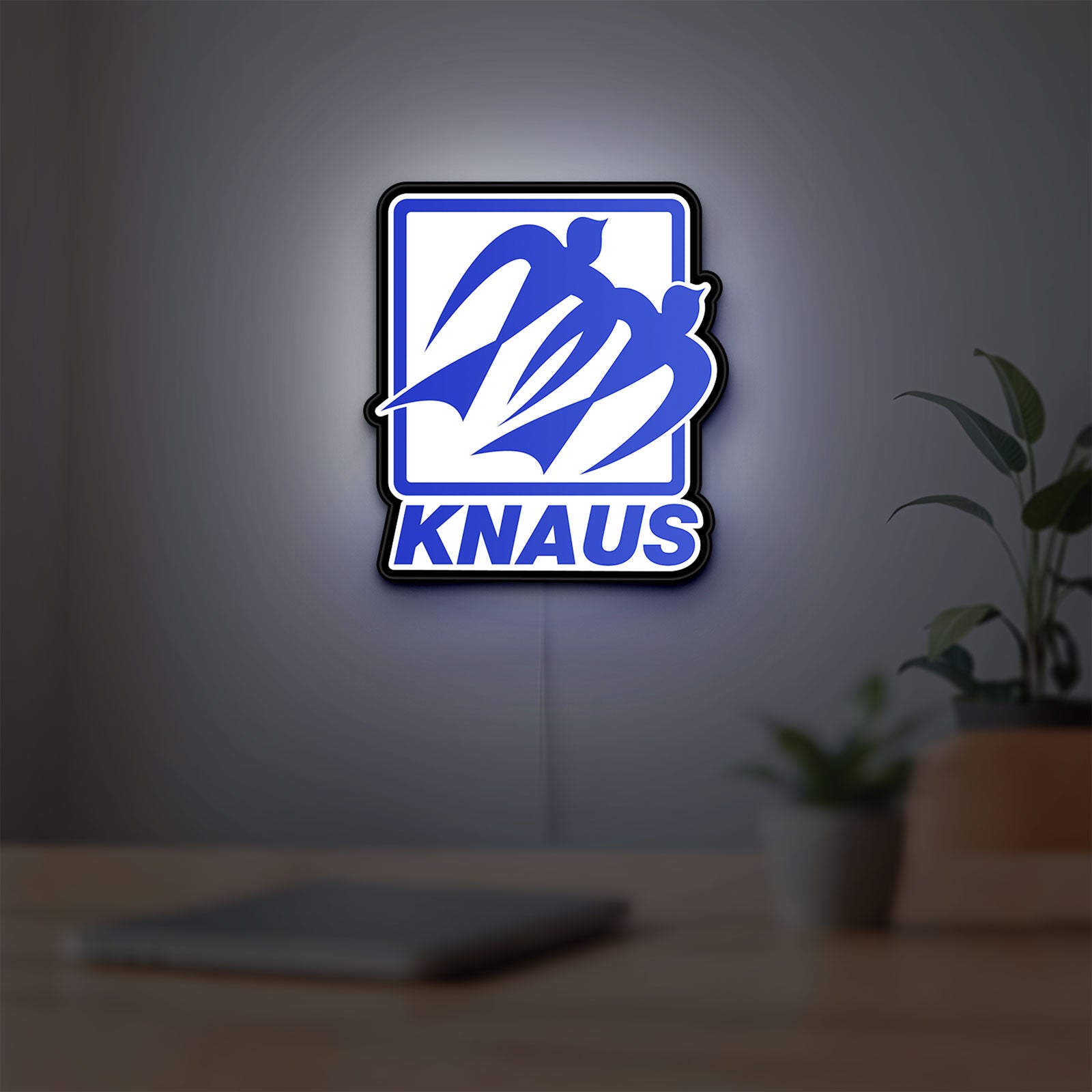 Knaus LED lightbox hanging on a room wall with soft blue light