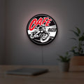 Cafe Racer LED lightbox hanging on a room wall with soft white light