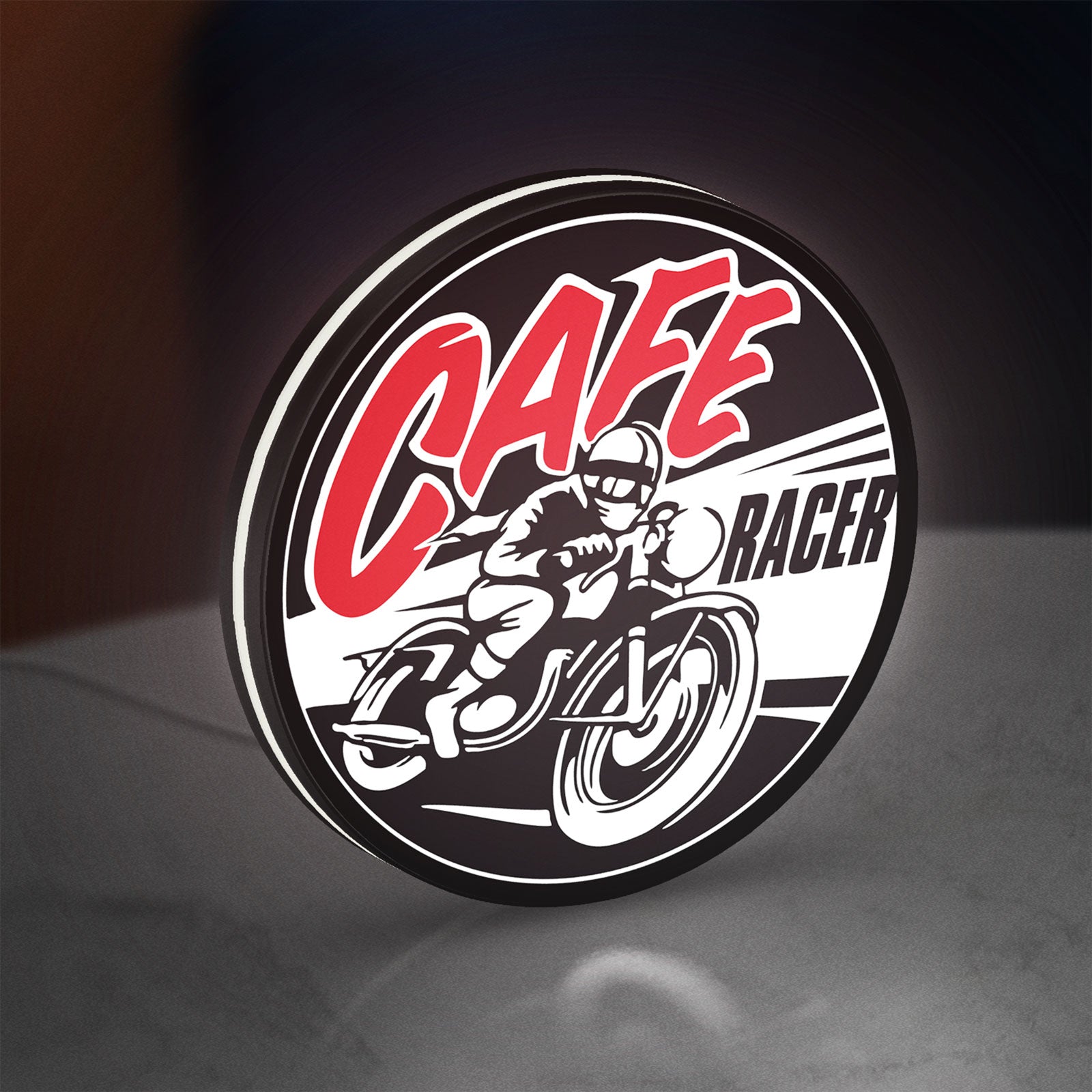 Cafe Racer LED lightbox standing on a desk from an angled side view with white glow