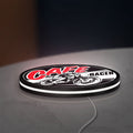Cafe Racer LED lightbox lying flat on a desk with white glow