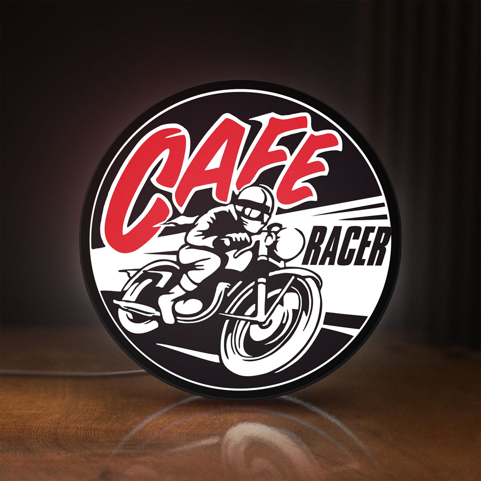 Front view of Cafe Racer LED lightbox sign glowing on a wooden desk