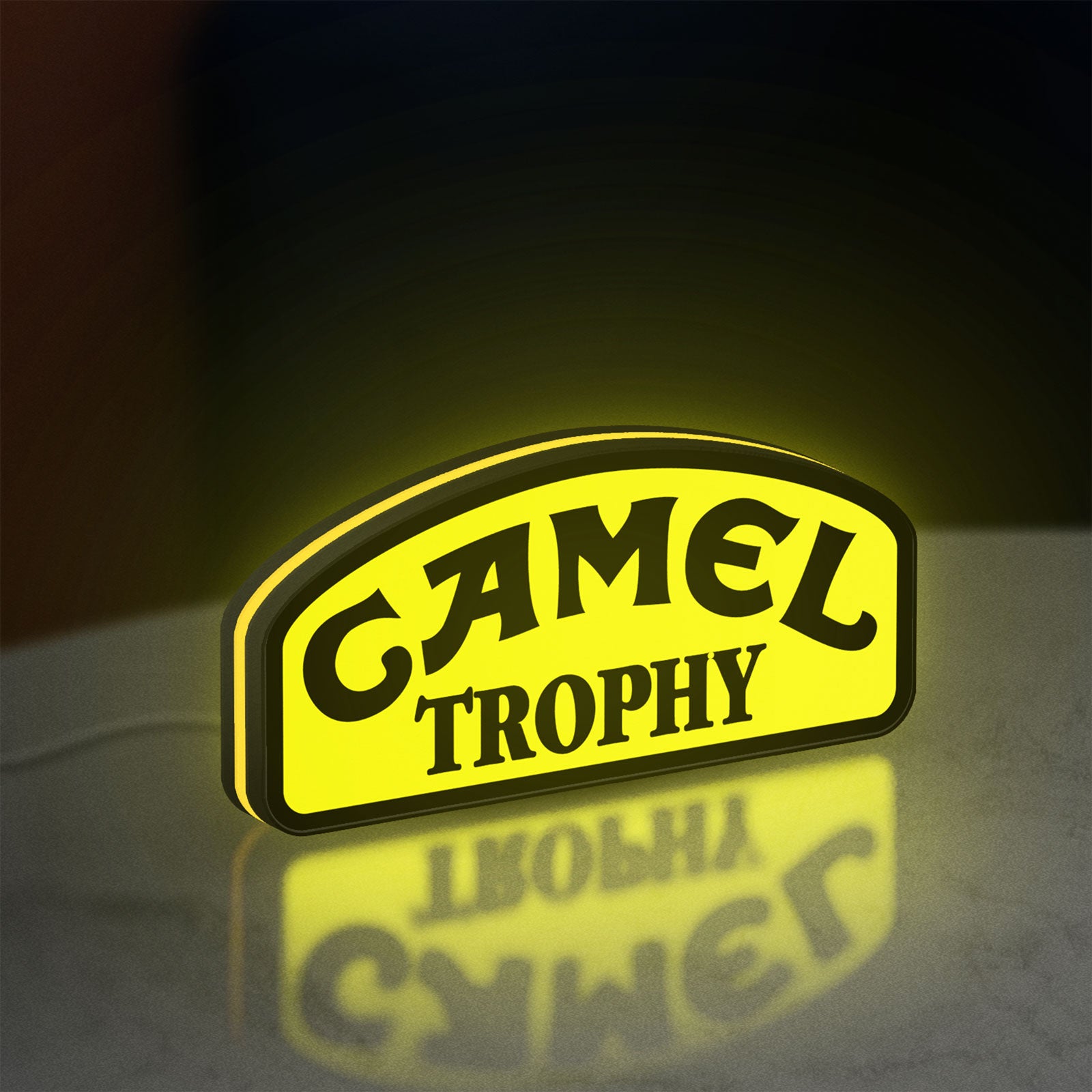 Camel Trophy LED lightbox standing on a desk from an angled side view with yellow glow