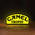 Front view of Camel Trophy LED lightbox sign glowing on a wooden desk