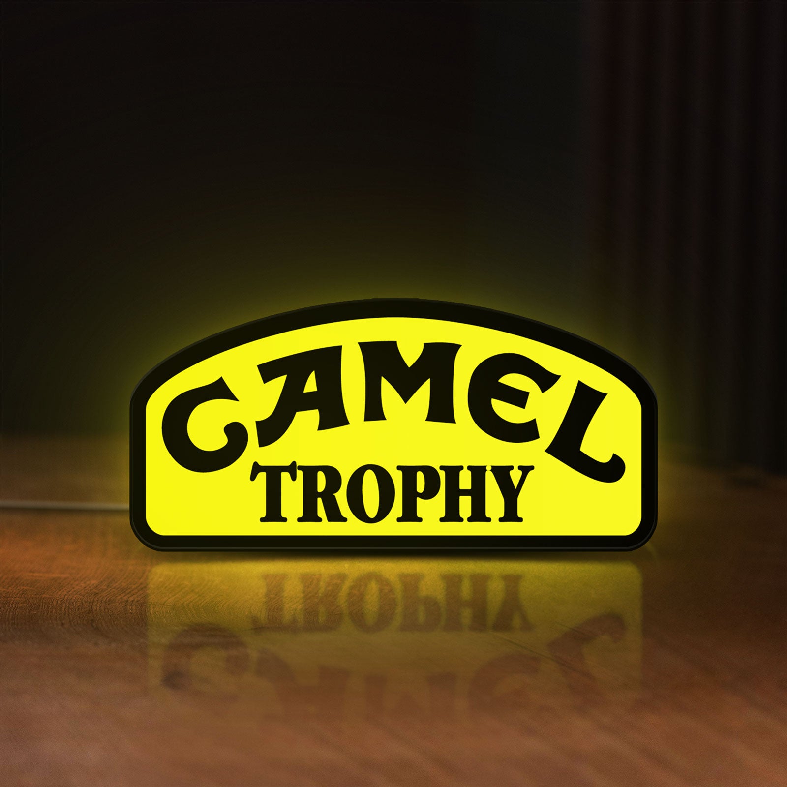 Front view of Camel Trophy LED lightbox sign glowing on a wooden desk