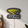 Unlit Cycra Racing LED lightbox mounted on a wall in daylight