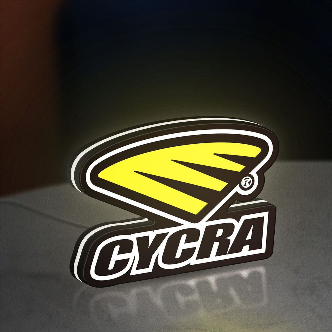 Cycra Racing LED lightbox hanging on a wall with white glow