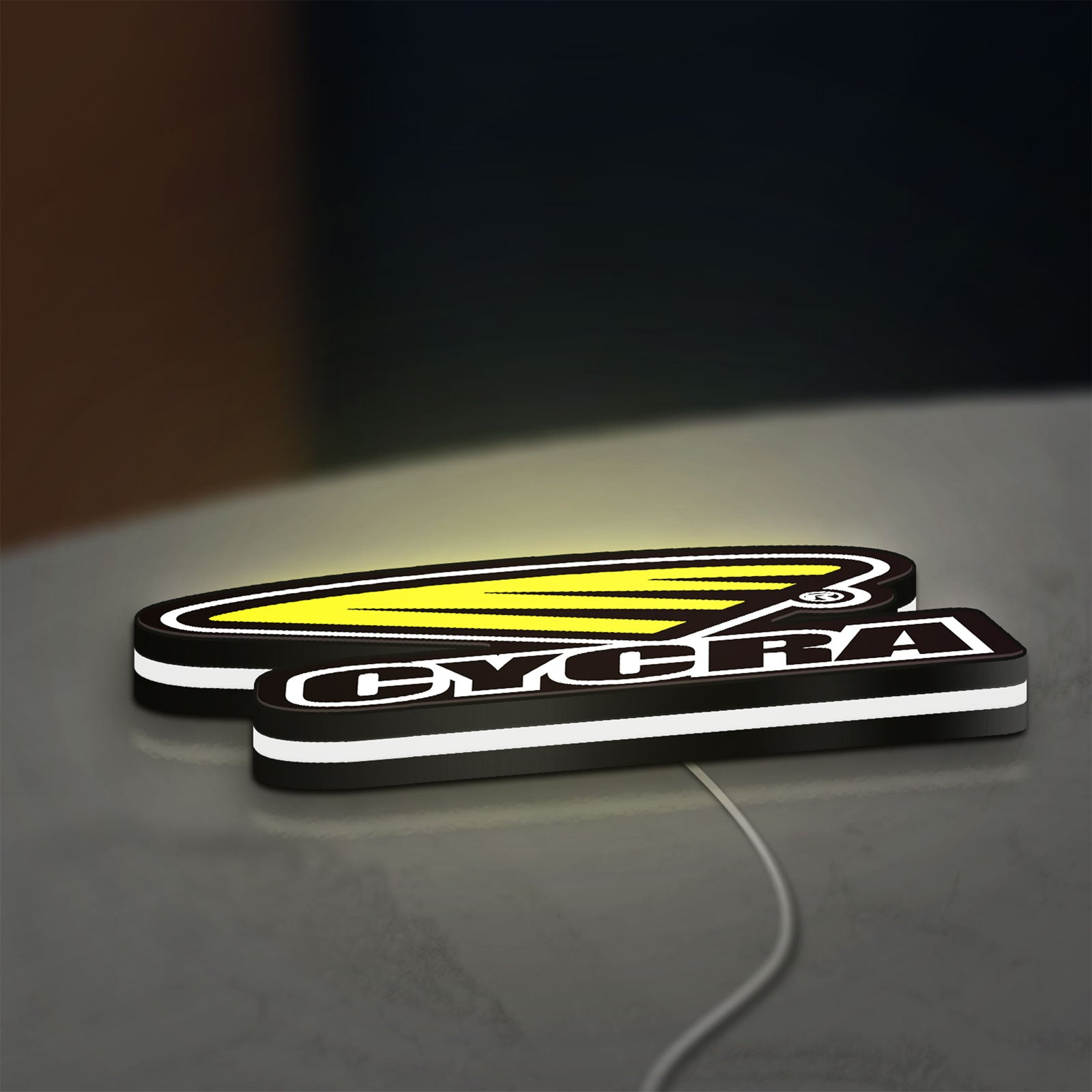 Cycra Racing LED lightbox lying flat on a desk with white glow