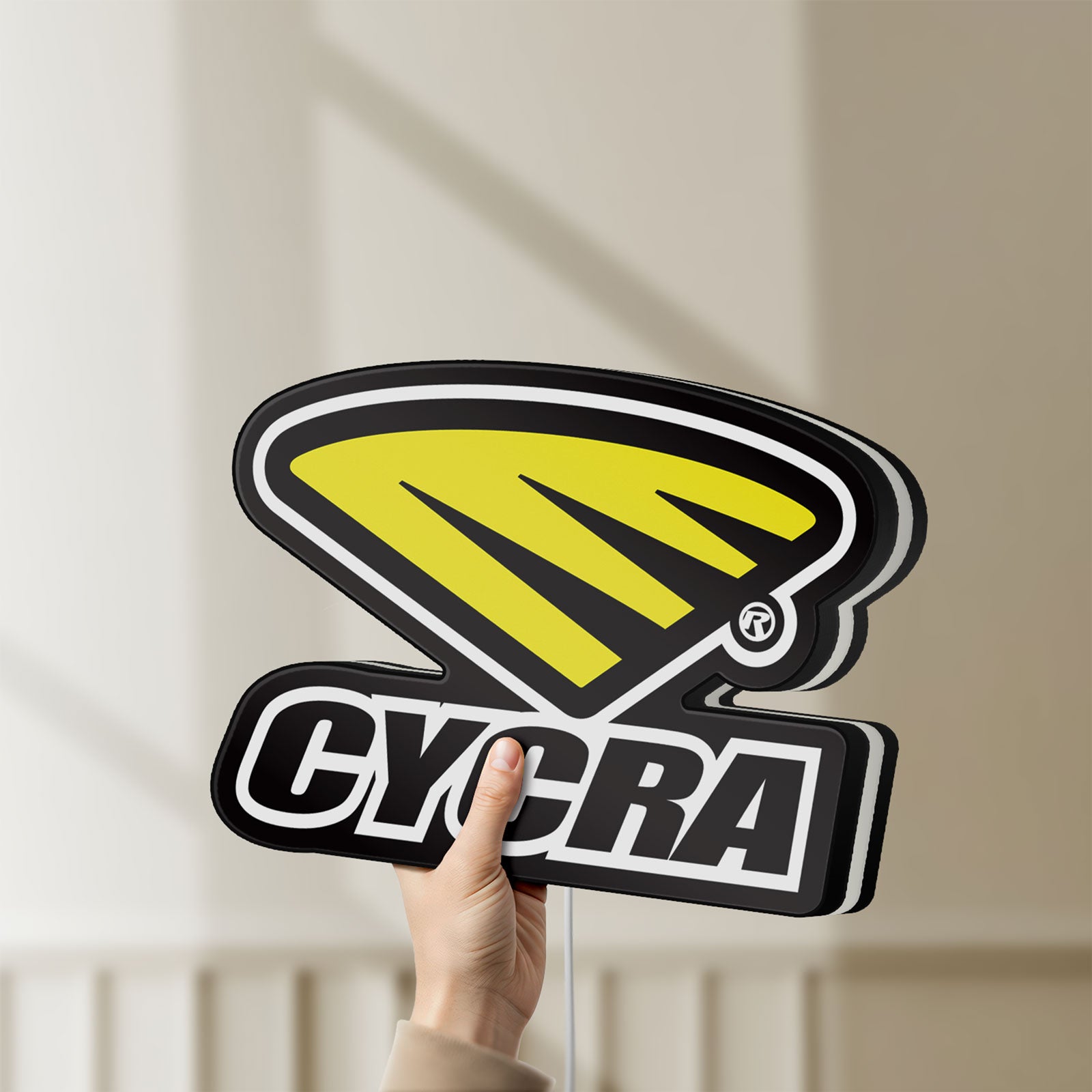 Unlit Cycra Racing LED lightbox held by hand to show size and details