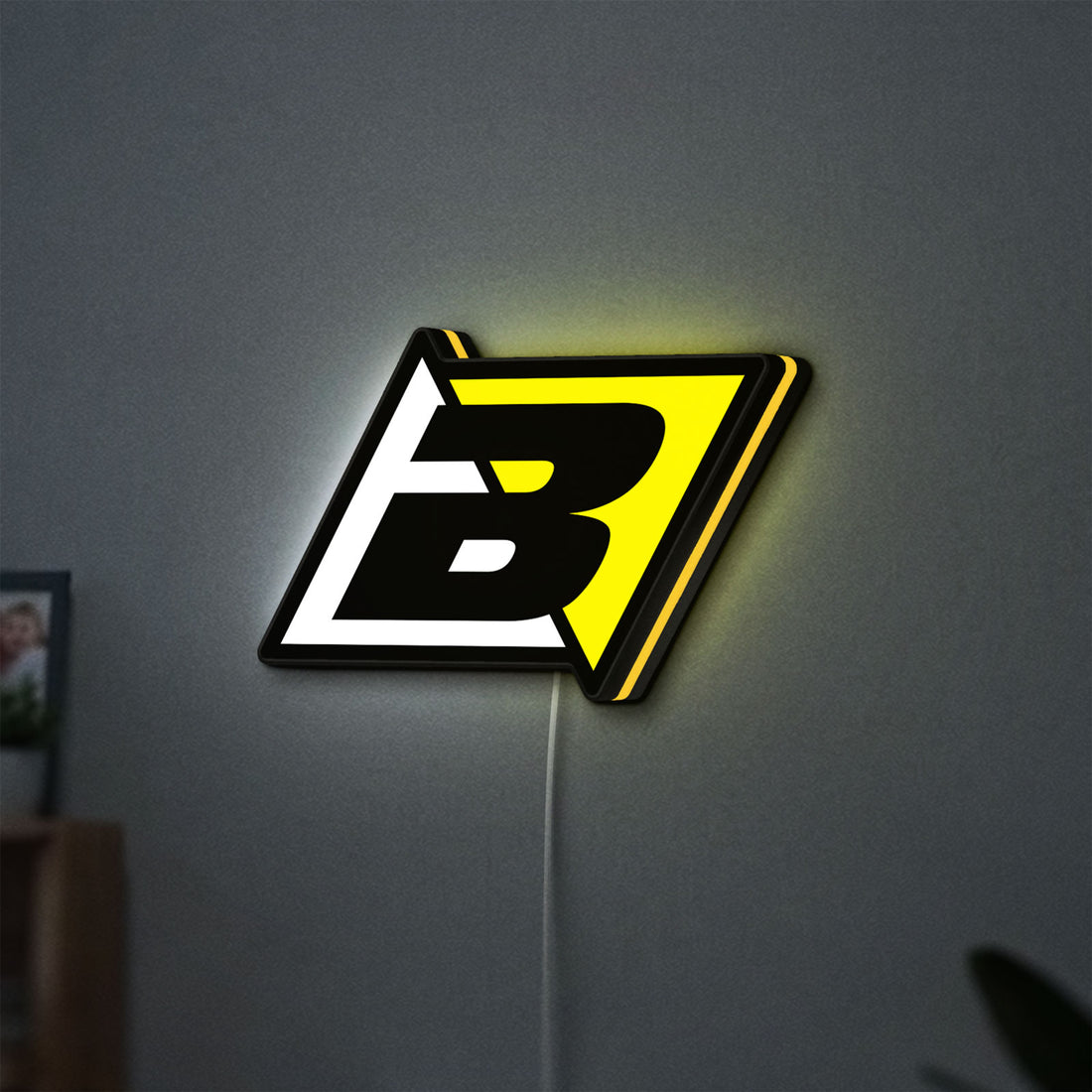Blackbird Racing LED lightbox hanging on a wall with yellow glow