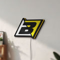 Unlit Blackbird Racing LED lightbox mounted on a wall in daylight