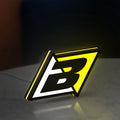 Blackbird Racing LED lightbox standing on a desk from an angled side view with yellow glow