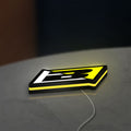 Blackbird Racing LED lightbox lying flat on a desk with yellow glow