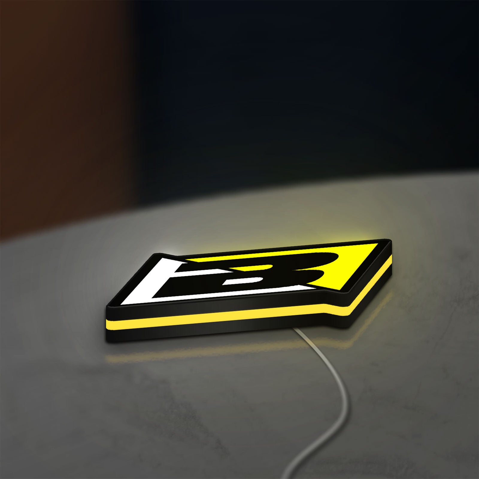Blackbird Racing LED lightbox lying flat on a desk with yellow glow